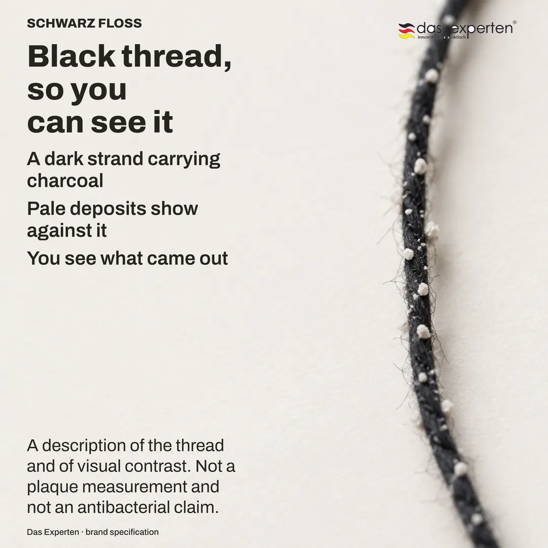 Contrast study: pale material against a dark fine strand, the visibility of one against the other being the whole subject